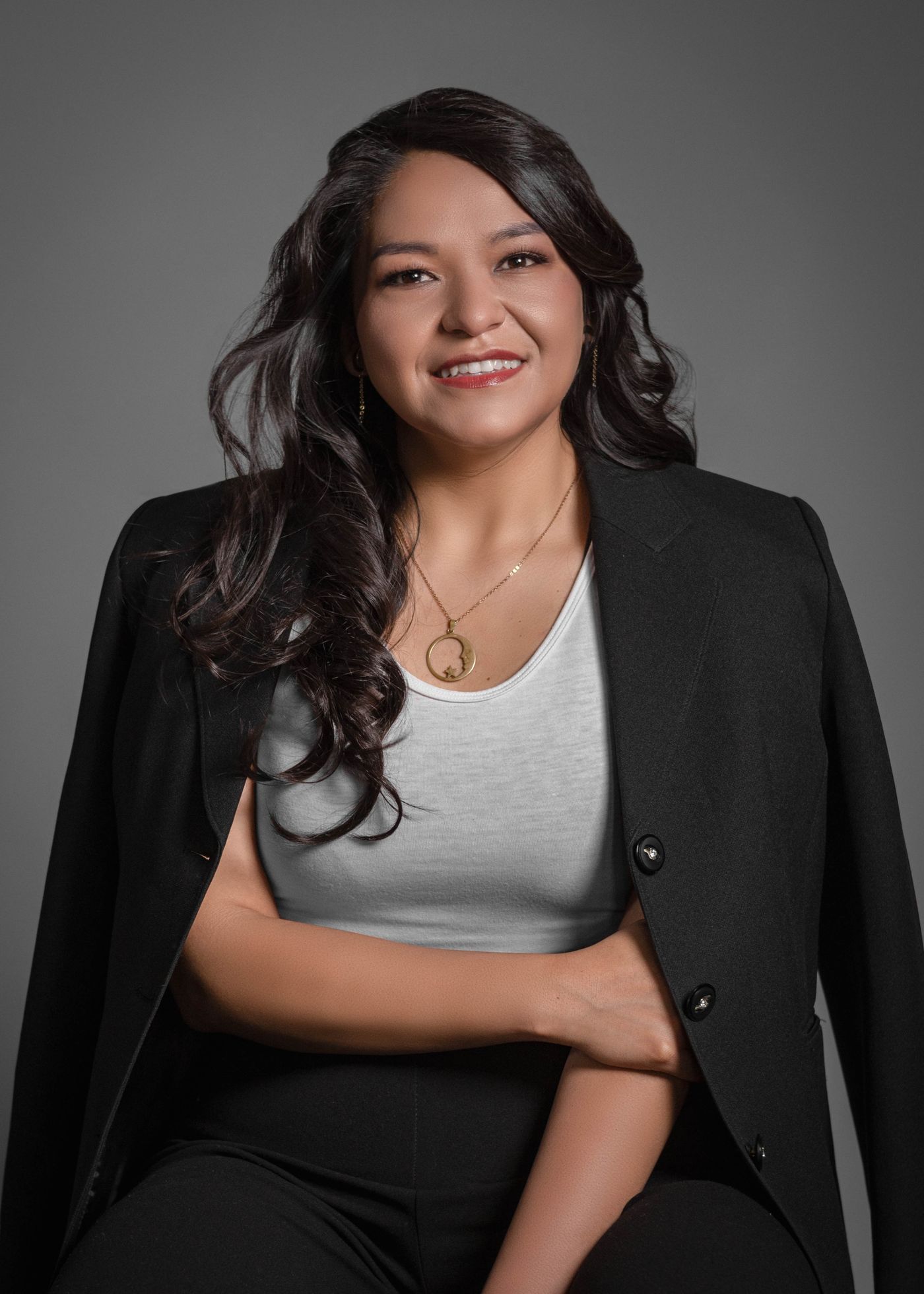 A smiling business owner in a dark blazer